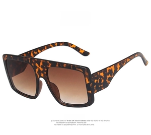 Detail of oversized leopard print sunglasses with gradient brown lenses and wide temples