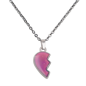 Close-up of heart-shaped puzzle pendant with pink-purple gradient and silver metal chain
