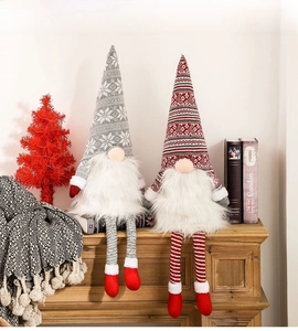 Close-up of Forest Gnome plush dolls with knitted hats on a wooden fireplace mantle