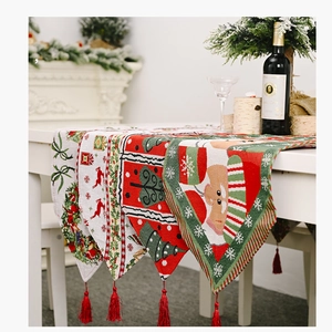 Detailed view of festive Christmas table runners with Santa and reindeer patterns