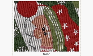 Detail of knitted Christmas table runner showing Santa Claus pattern on green fabric