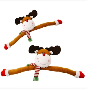 Detail of plush Christmas reindeer decorations with long limbs and striped scarves
