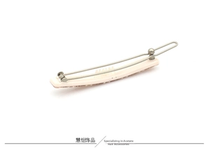 Detail view of pink acetate hair clip with silver metal spring buckle mechanism