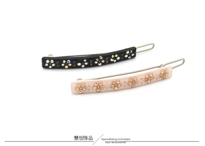Detail of acetate hair clips set in black and pink with champagne rhinestone flowers