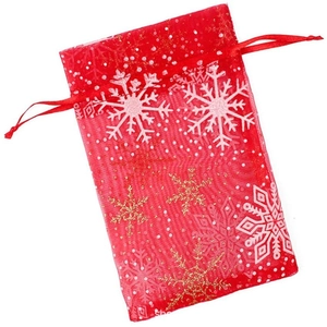Red organza Christmas gift bag with gold snowflakes and drawstring closure on white background