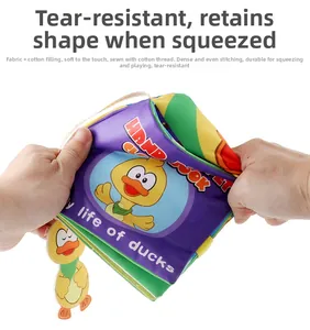 Detail showing the tear-resistant duck story cloth book being pulled by hands
