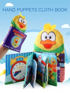Detail of yellow duck hand puppet cloth book showing interactive pages and soft fabric
