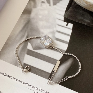 Detailed view of 925 silver bracelet with square zircon on fashion magazine background