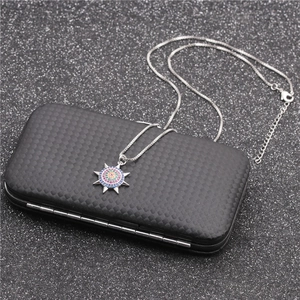 Silver sun pendant necklace with colorful zircon stones on black jewelry box
