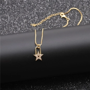 Detail view of a gold star pendant necklace with zircons and lock design on black stand