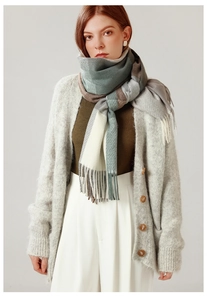Close-up of soft plaid scarf fabric with elegant fringe tassels in morandi tones