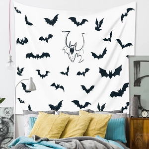 Detail of bohemian Halloween wall tapestry featuring black bat silhouettes on white fabric