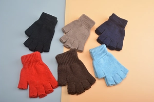 Flat lay of knit wool fingerless gloves in black, beige, navy, red, brown and blue