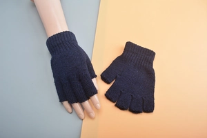 Detail of dark blue knitted fingerless wool gloves showing rib knit texture and warmth