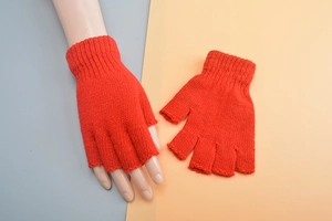 Detailed view of red knitted fingerless wool gloves showing texture and half-finger design