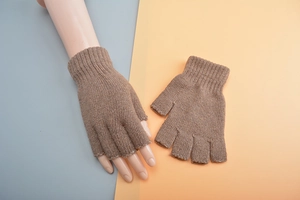 Detailed knit texture of brown wool fingerless gloves shown on hand and flat lay
