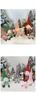 Detail of colorful knitted Christmas gnomes with LED lights and striped patterns