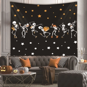 Detail of Halloween tapestry with dancing skeletons and stars hanging over a gray sofa