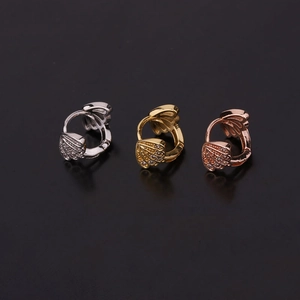 Three hoop earrings in silver gold and rose gold with zircon shell charms on black background
