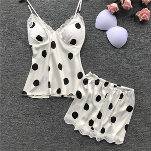 Polka dot satin sleepwear set with lace trim and removable pads on textured background