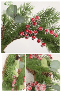 Macro detail of Christmas wreath with red berries, pine cones and eucalyptus leaves