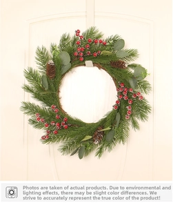 Close-up of Christmas wreath with red berries, pine cones and eucalyptus leaves