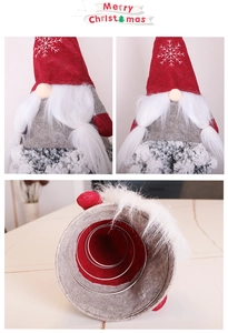 Detail view of gnome Christmas tree topper with red felt snowflake hat and metal spiral base