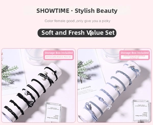 Detail view of 8-piece hair tie sets in black and light blue with pearl and bow accents