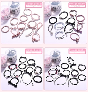 Detail of 10-piece hair tie set with pearls and bows in a clear storage jar