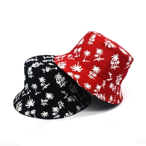 Detail of red and black bucket hats with tropical coconut tree and flamingo prints