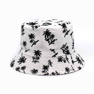 Detail of white canvas bucket hat with black palm tree and flamingo tropical prints