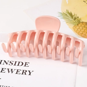 Pink matte large claw clip with hollow design on aesthetic background decor