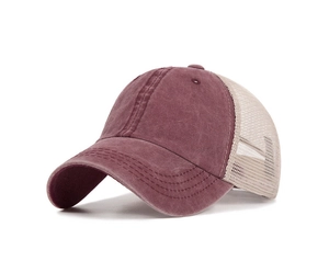Detailed close-up of breathable cotton mesh and stitching on the wine red trucker hat