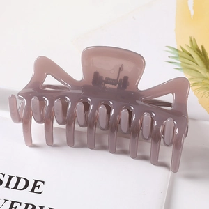 Close-up of translucent grey-brown geometric hair claw clip with hollow rectangular top
