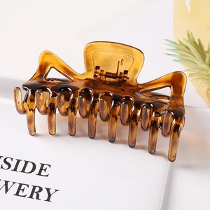 Large amber tortoiseshell hair claw clip for women featuring a minimalist geometric design