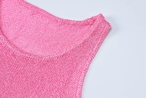 Detail of round neckline and knit texture on hot pink sleeveless summer dress