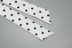 Close-up of polka dot fabric detail showing high-quality stitching and smooth texture