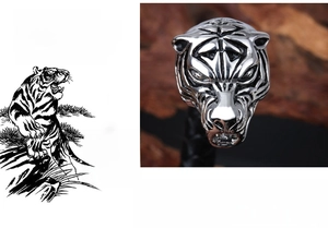 Detailed close-up of a silver tiger head bracelet with intricate carved metallic textures