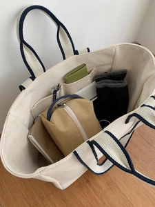 Top view of beige canvas tote bag interior showing spacious compartments and storage capacity