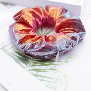 Detail of laser gradient scrunchie featuring metallic shine and a hidden zipper pocket