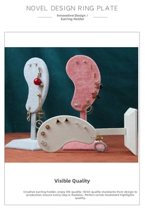 Detail view of velvet ear stud display stands showcasing various earrings and jewelry