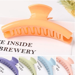 Detail view of large hollow star hair claws in various vibrant macaron colors