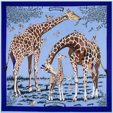 Detail of blue silk scarf featuring giraffe illustration and elegant border patterns