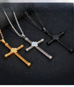 Detailed view of hip hop cross pendants in gold, silver, and matte black steel finishes