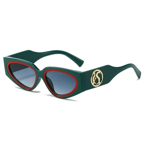 Retro cat-eye sunglasses with green frame, red accents, and blue gradient lenses