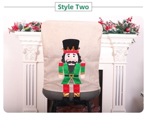Detailed view of nutcracker soldier chair cover with festive red and green burlap fabric