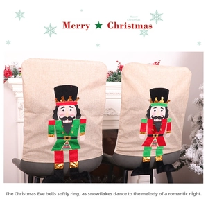 Detail of nutcracker appliqué on linen Christmas chair covers for festive dining decor