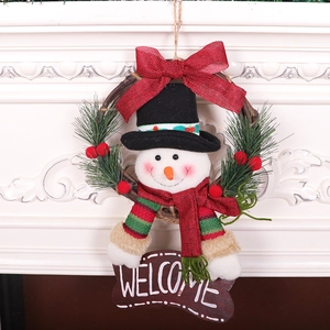 Christmas snowman rattan wreath with a welcome sign and pine needles on a white fireplace