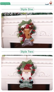 Detail of Christmas wreath with reindeer, Santa, pine needles and welcome signs on white fireplace