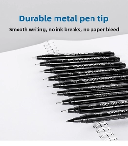 Detail of nine waterproof drawing pens on a notebook featuring durable metal tips